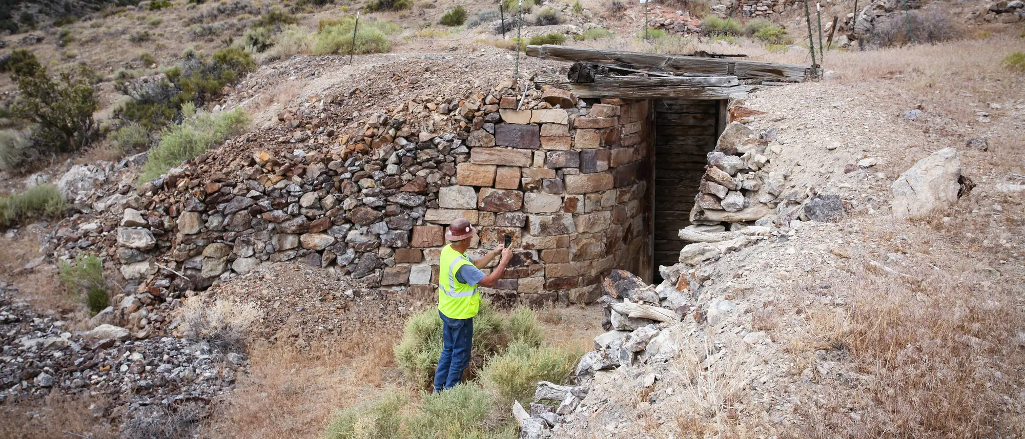 A dry-stone portal to a historic mine adit on a Nevada hillside